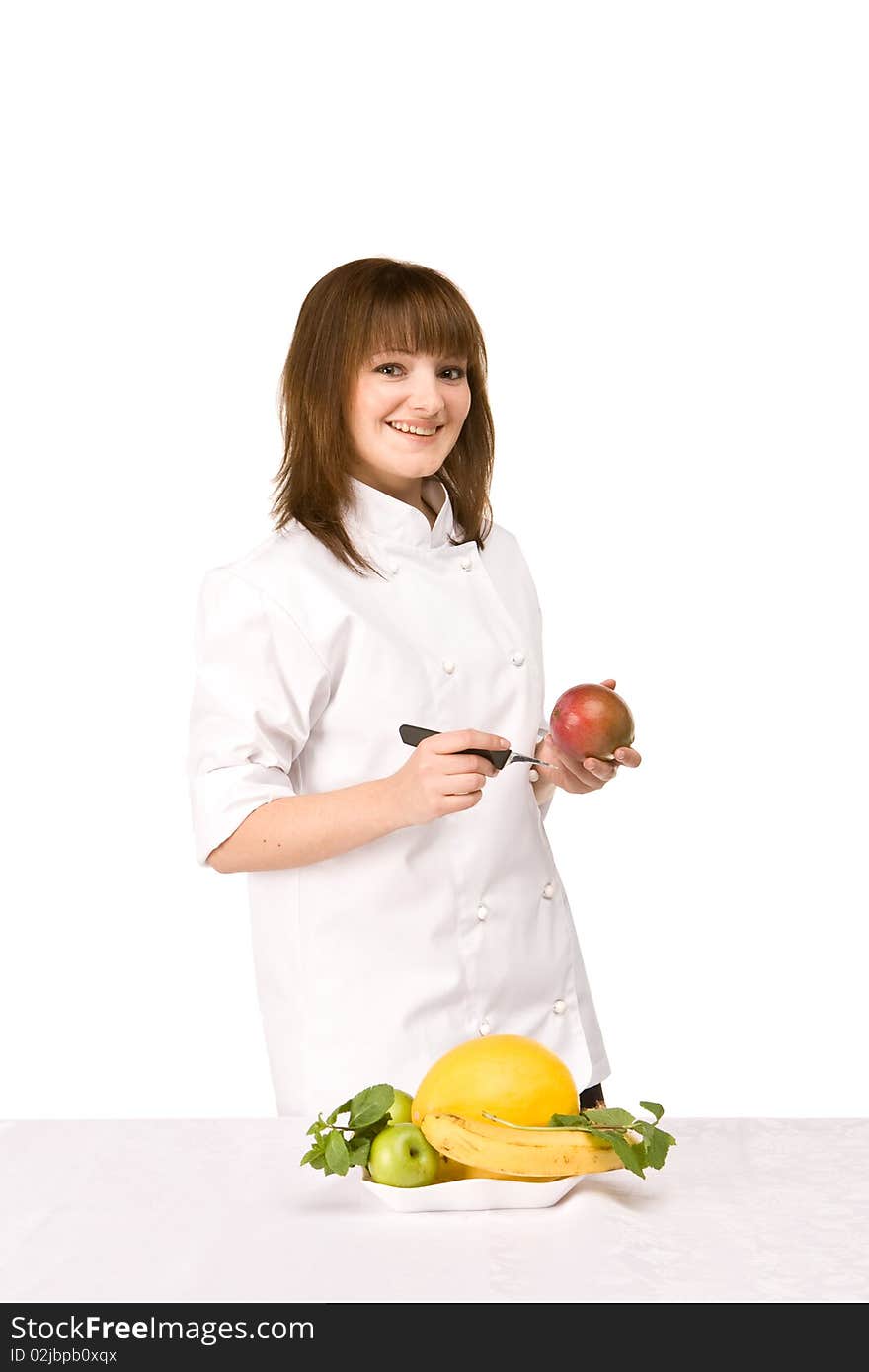 Cook girl holding a knife and a mango