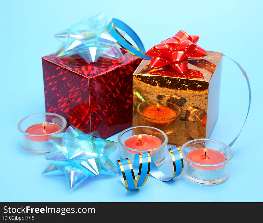 Gifts and candles on a blue background