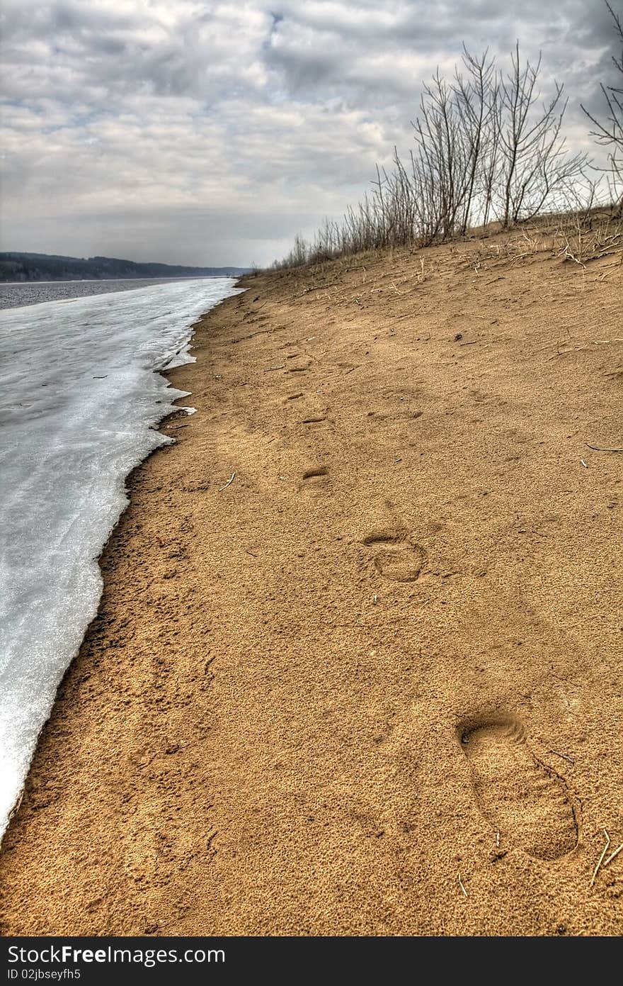 Early spring. Traces on sand along river bank. Russia, the Udmurt republic.