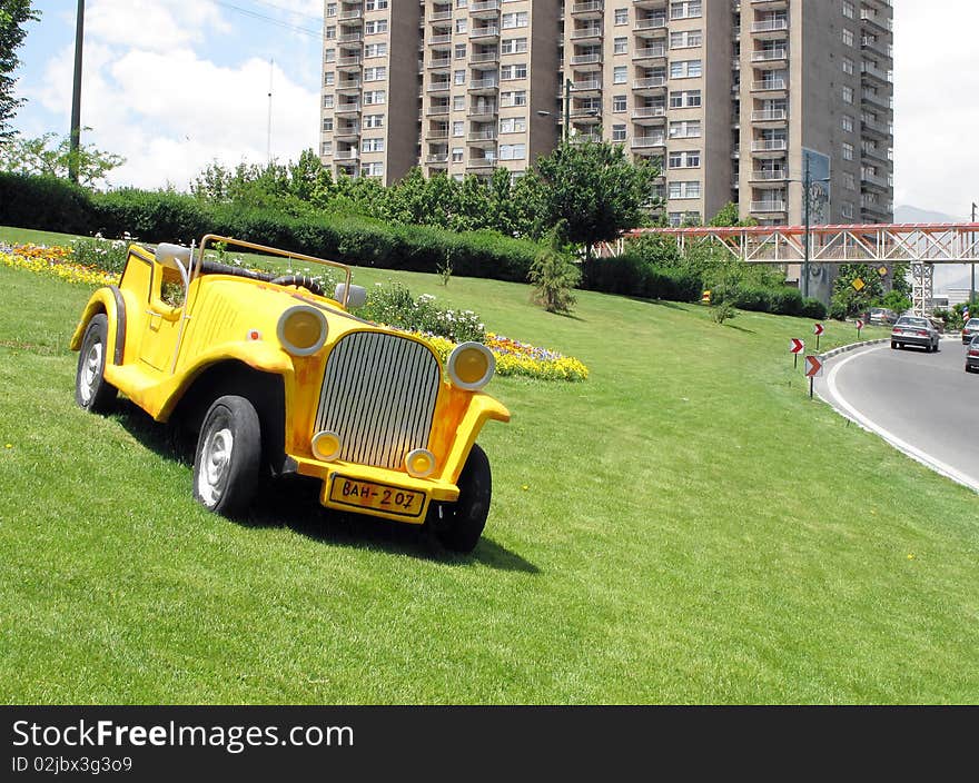 Display of decorative sculptured car on the side of a highway