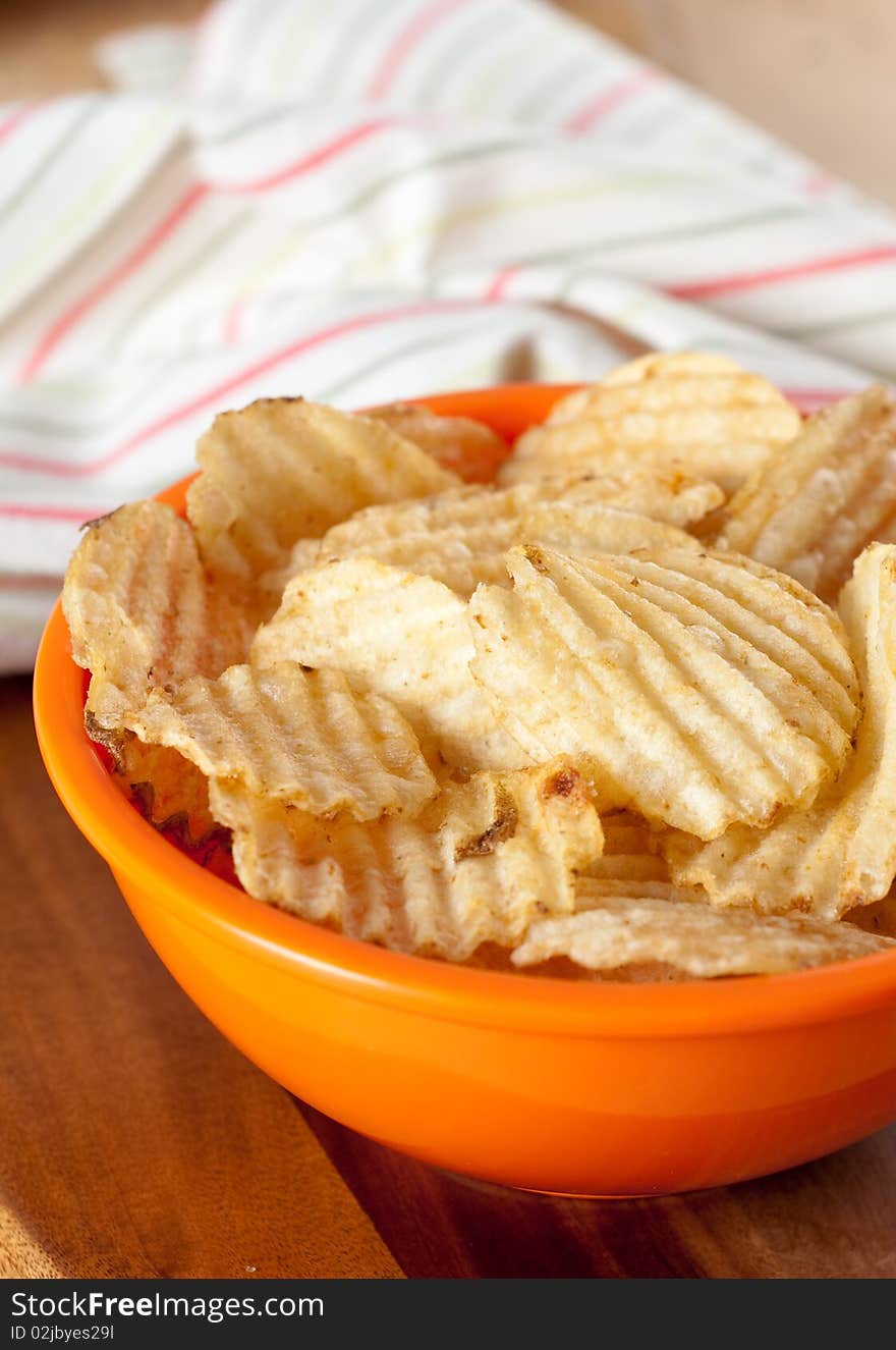 Potato Chips in Orange Bowl and kitchen Towel