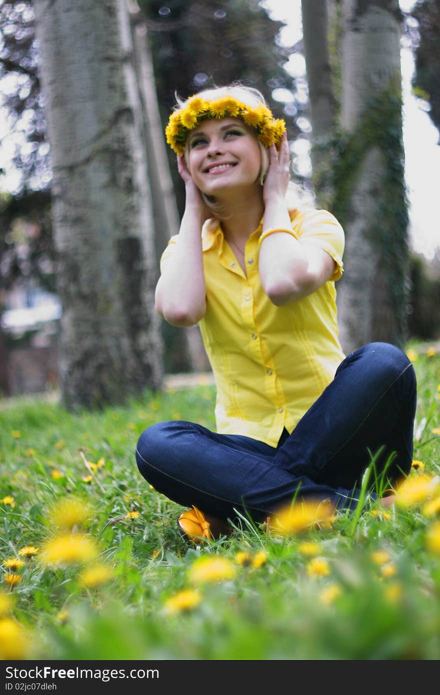 The young pretty girl on a glade of dandelions. The young pretty girl on a glade of dandelions