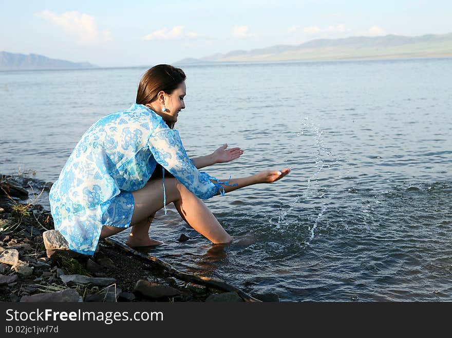 The fine girl on coast of the river