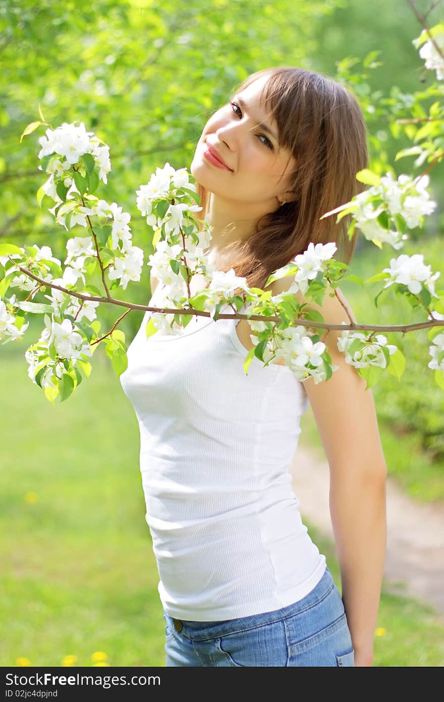 Beautiful girl about to apple tree