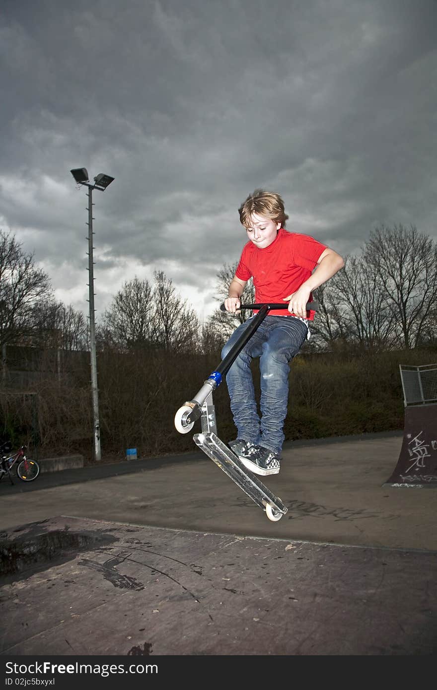 Boy going airborne with a scooter