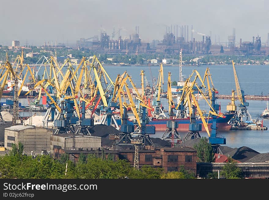 Industrial views of docks and big factory on the background. Heavy air polluiton is visible. Industrial views of docks and big factory on the background. Heavy air polluiton is visible.
