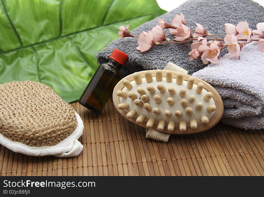 Massage brush with sponge and towel on mat. Massage brush with sponge and towel on mat