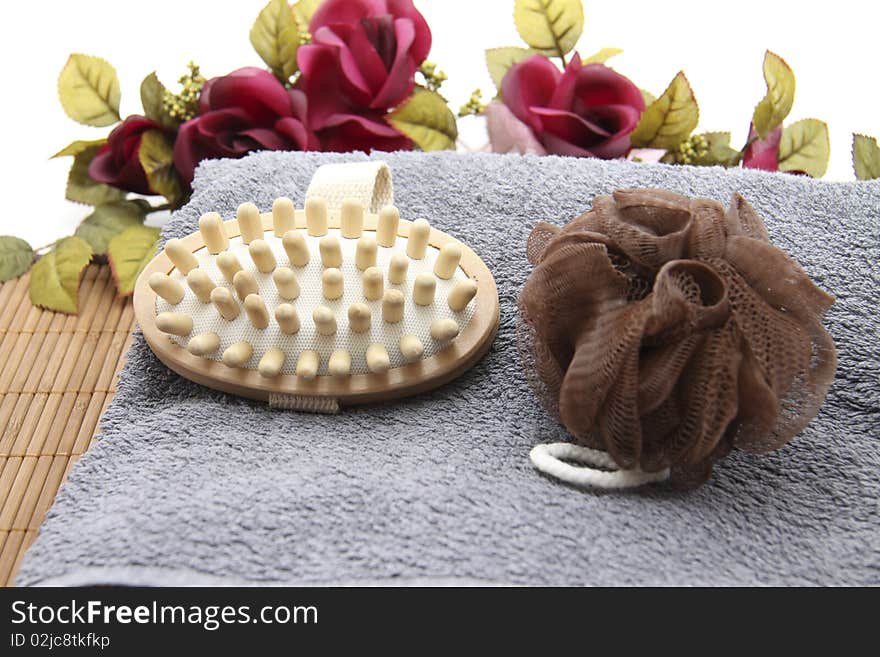 Massage brush with sponge and flowers on mat. Massage brush with sponge and flowers on mat