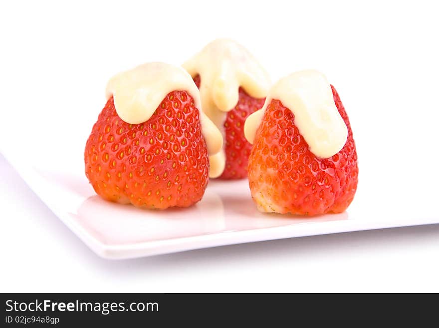 Strawberries with vanilla pudding on plate isolated