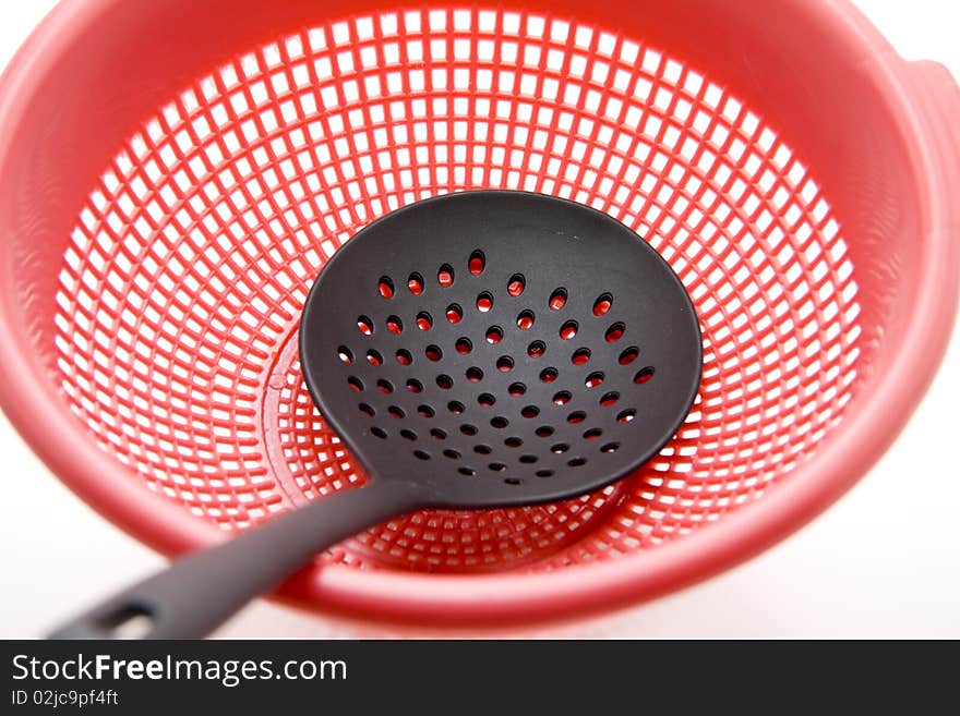 Ladle with kitchen sieve onto white background. Ladle with kitchen sieve onto white background