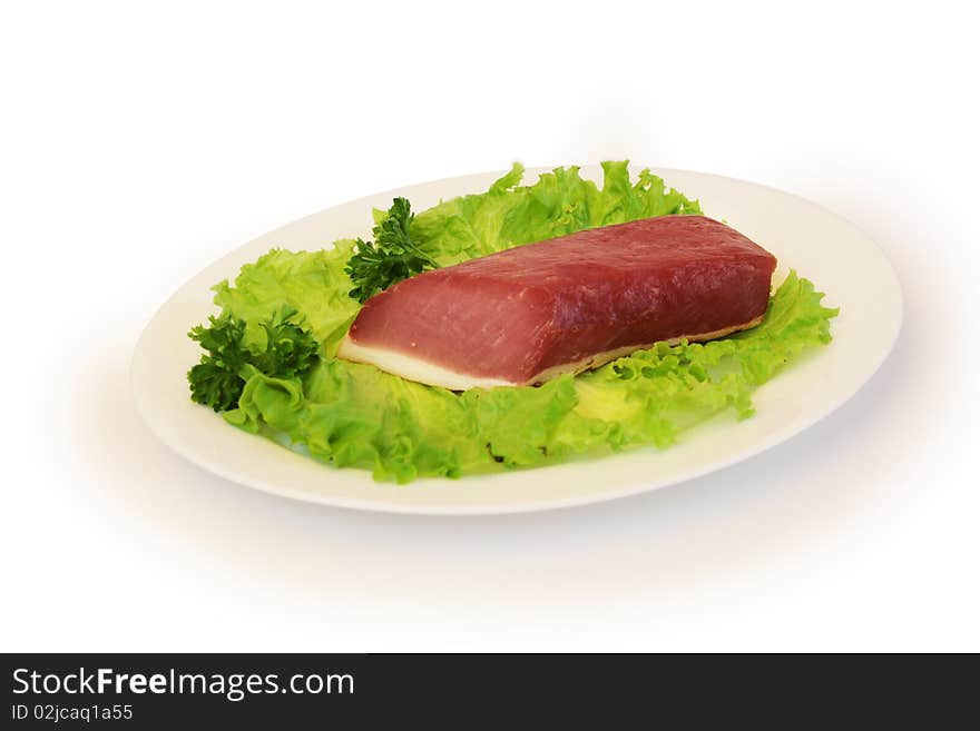 Slice of ham with green salad on white plate. Slice of ham with green salad on white plate