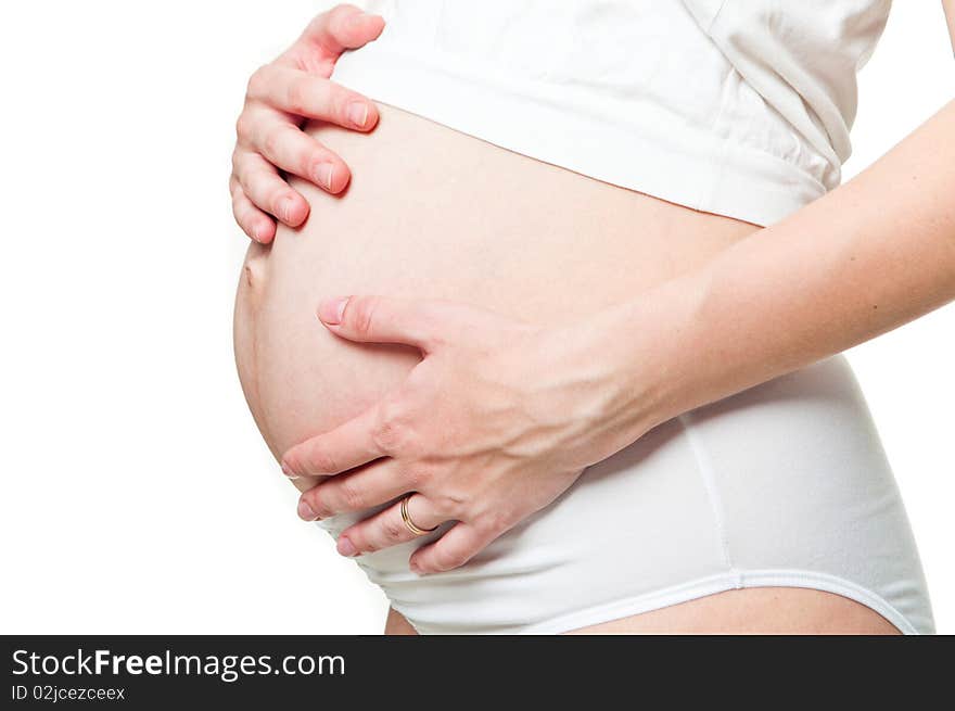 Close-up of a pregnant woman holding her hands on her tummy