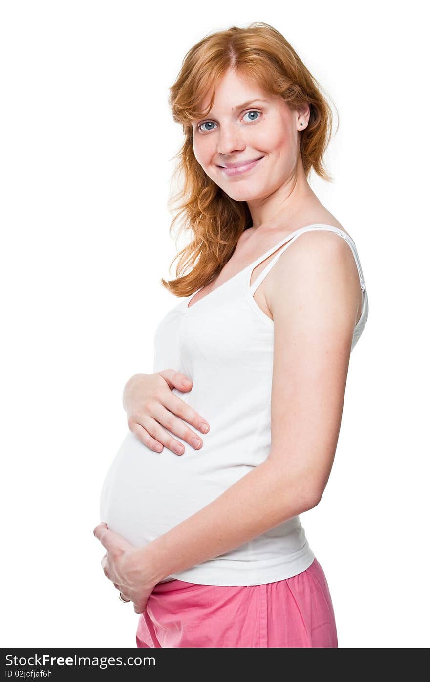 Young pregnant woman holding her hands on her tummy