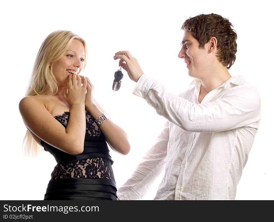 Man is presenting car keys for his girl. Isolated on white.