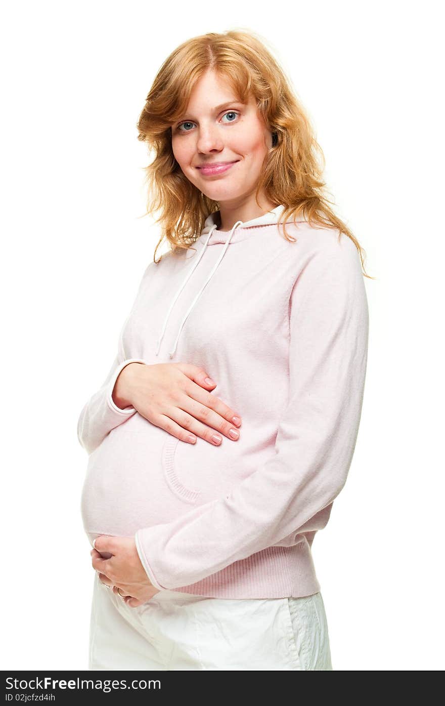 Young pregnant woman holding her hands on her tummy