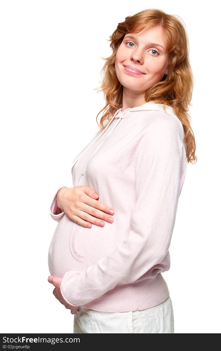 Young pregnant woman holding her hands on her tummy. Young pregnant woman holding her hands on her tummy