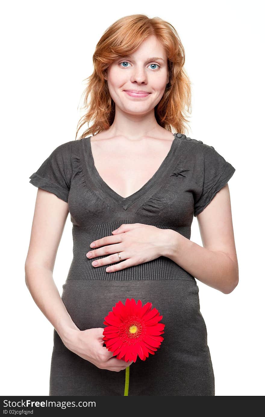 Young pregnant woman holding her hands on her tummy with red flower. Young pregnant woman holding her hands on her tummy with red flower