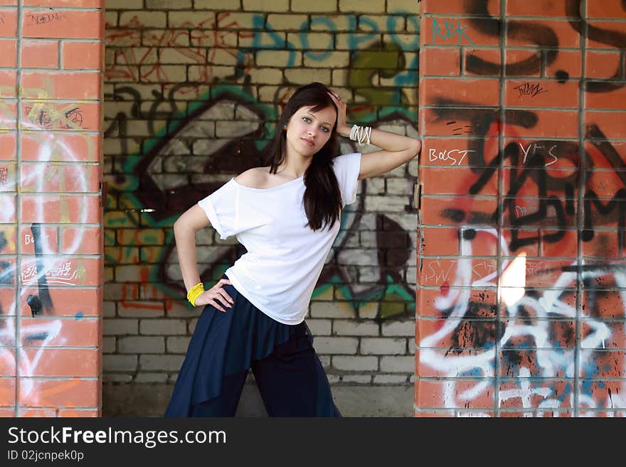 Young  girl near the walls with graffiti