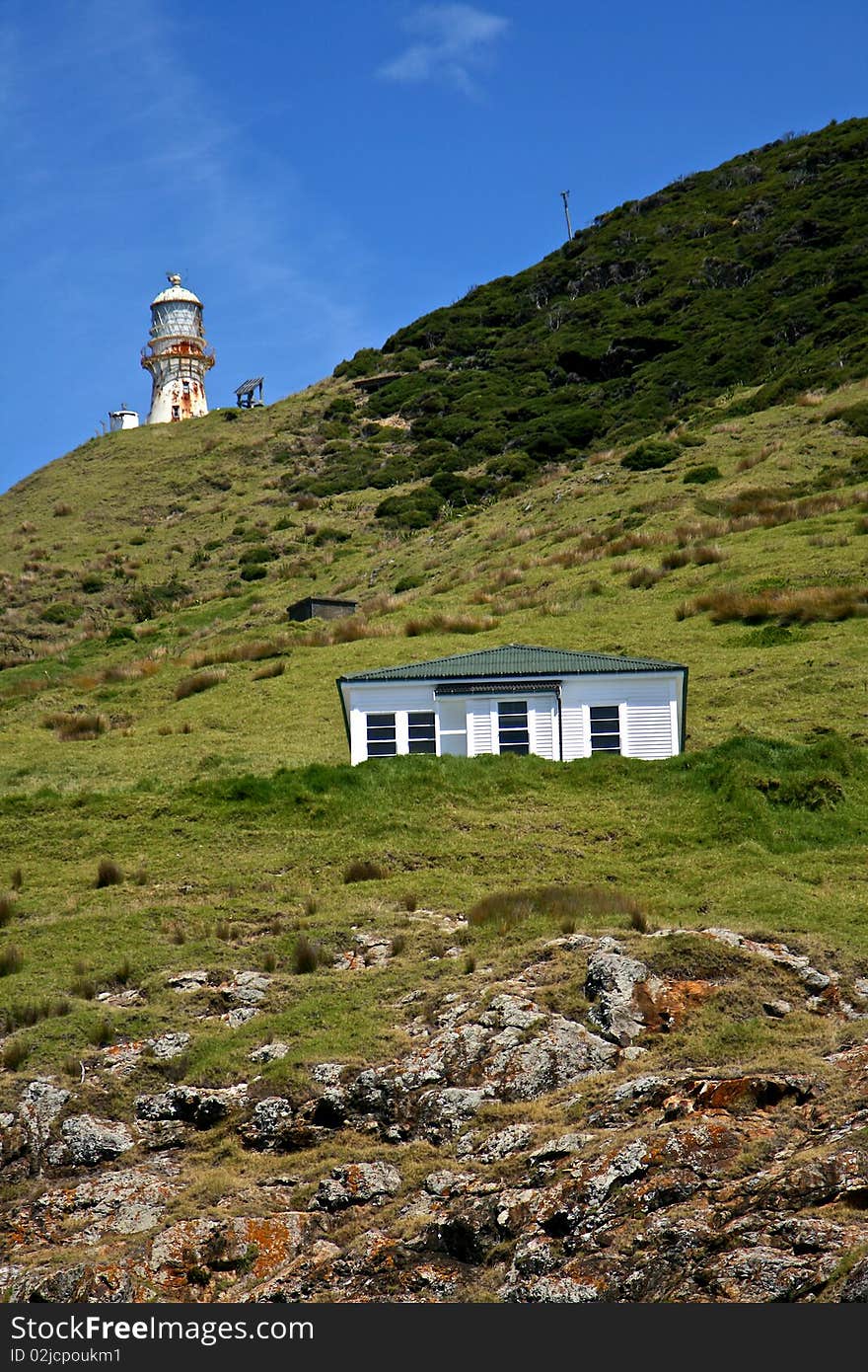 Light tower and little house located on the hill,Bay of Islands,New Zealand. Light tower and little house located on the hill,Bay of Islands,New Zealand