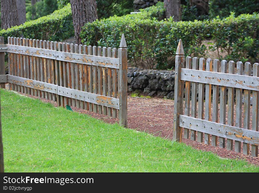 Wood fence delimitating grass park. Wood fence delimitating grass park