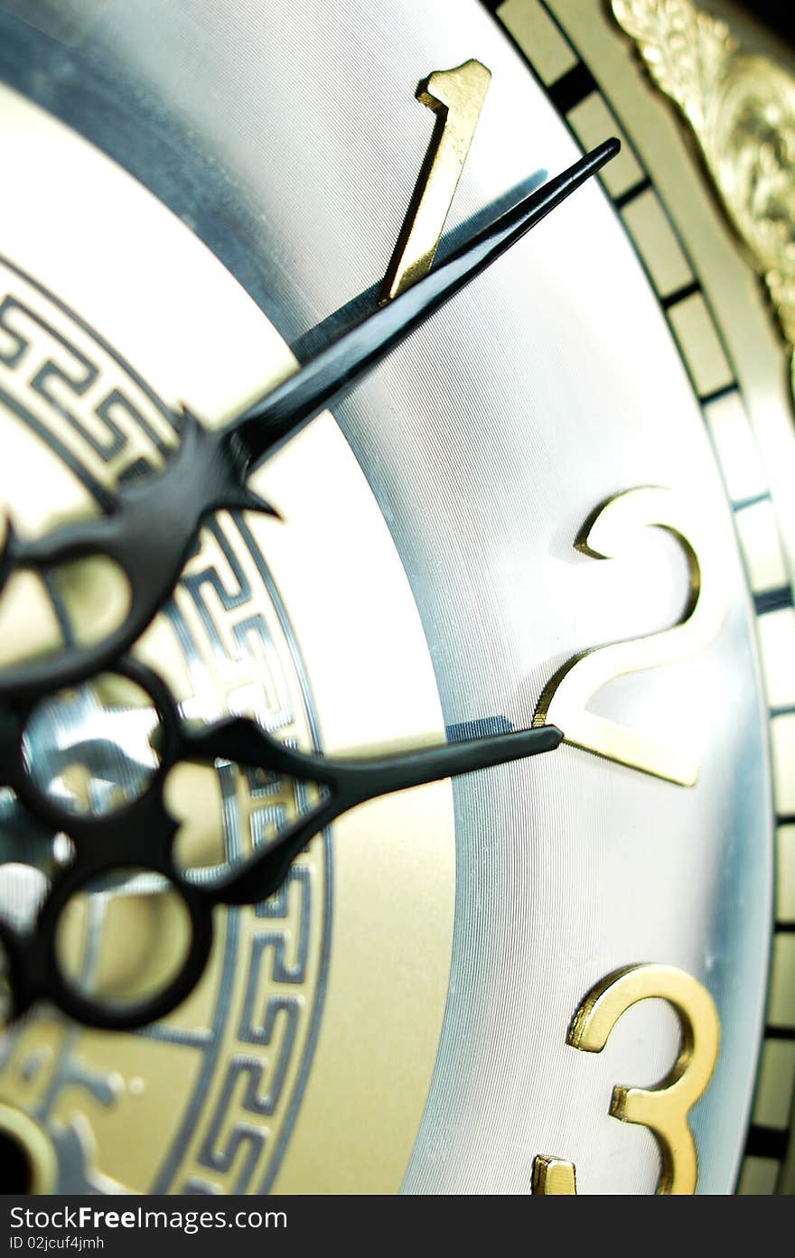 Close view of the hour and minute hands of an antique clock. Close view of the hour and minute hands of an antique clock