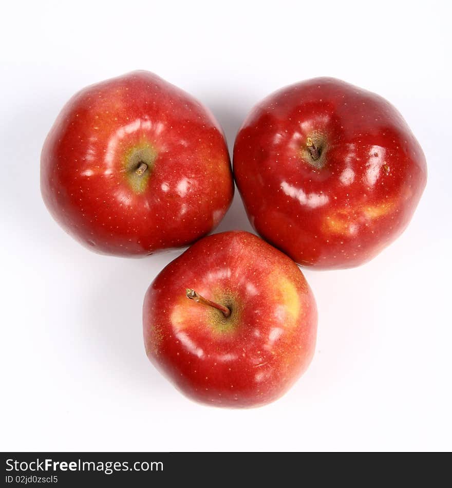 Three red apples on white background