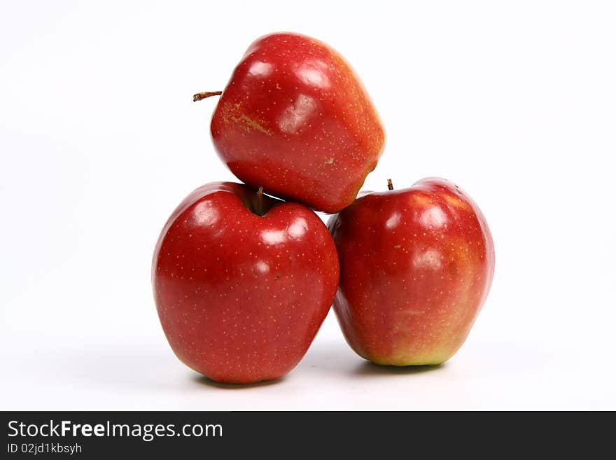 Three red apples on white background