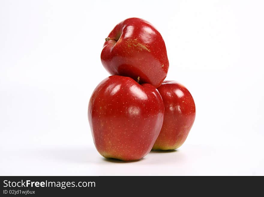 Three red apples in a stack on white background. Three red apples in a stack on white background