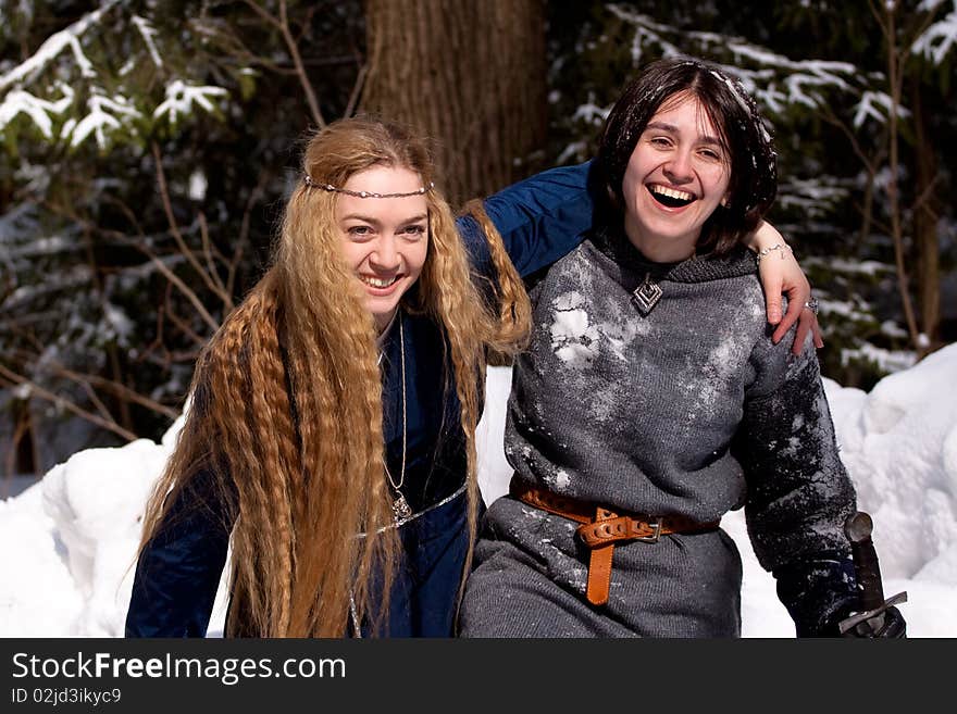 Two ladies in medieval dresses in winter forest. Two ladies in medieval dresses in winter forest