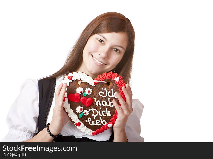 Bavarian woman in love holds Oktoberfest heart. Isolated on white background.