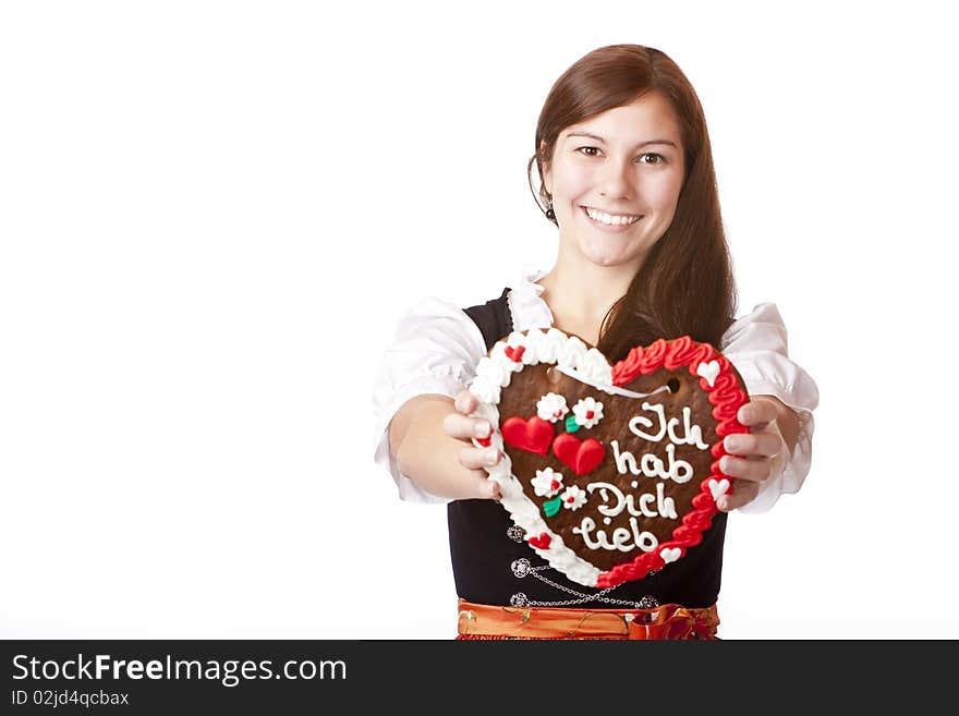 Bavarian woman in love holds Oktoberfest gingerbread heart. Isolated on white background. Bavarian woman in love holds Oktoberfest gingerbread heart. Isolated on white background.