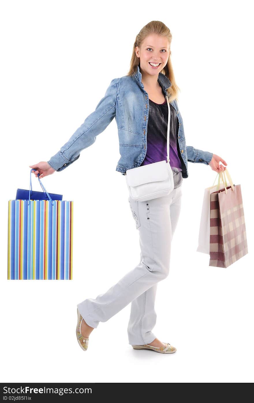 Young girl with purchases on white background