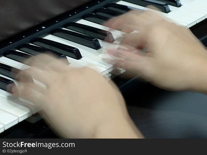 Playing very fast on a piano. Playing very fast on a piano.