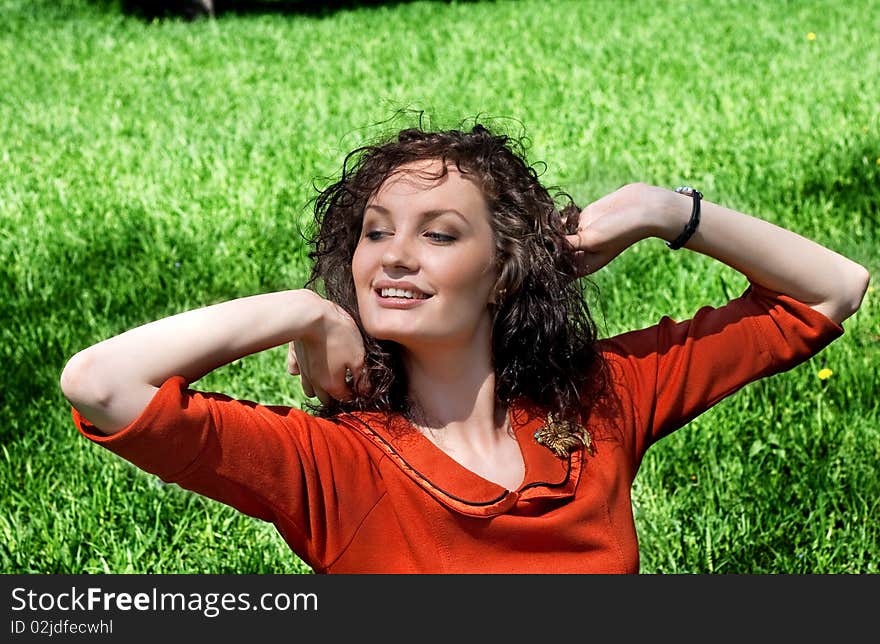 Young woman stretches in a grass