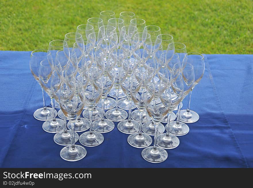 A couple of glasses joined on a table.