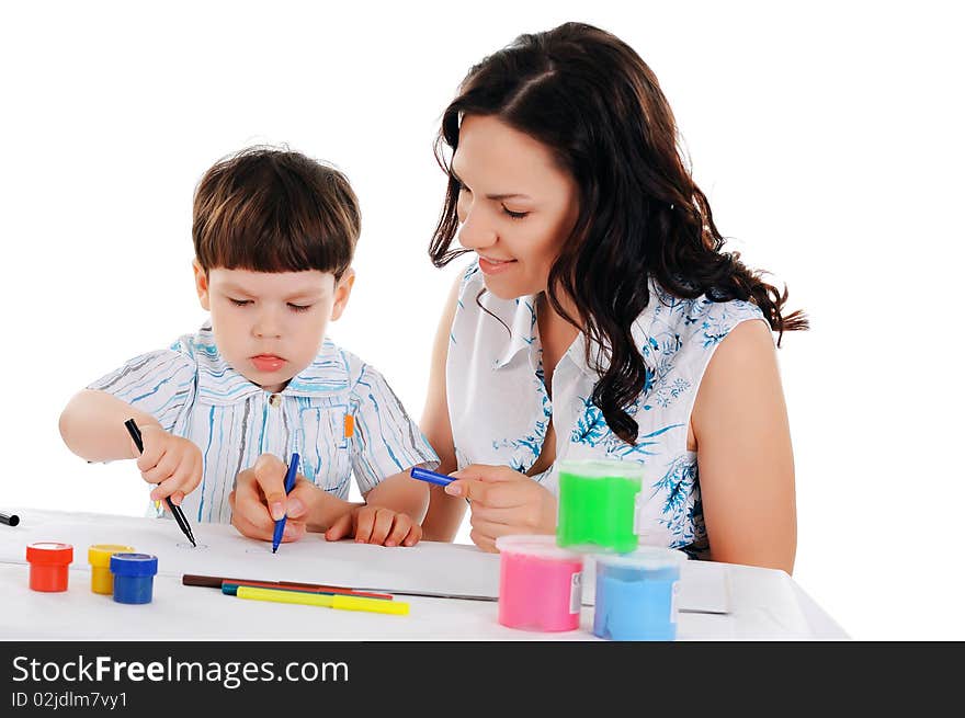 Young mother and her little son paint colors in this album. Young mother and her little son paint colors in this album