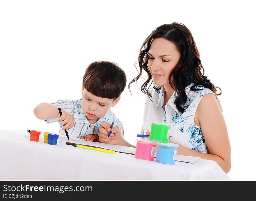 Young mother and her little son paint colors in this album. Young mother and her little son paint colors in this album