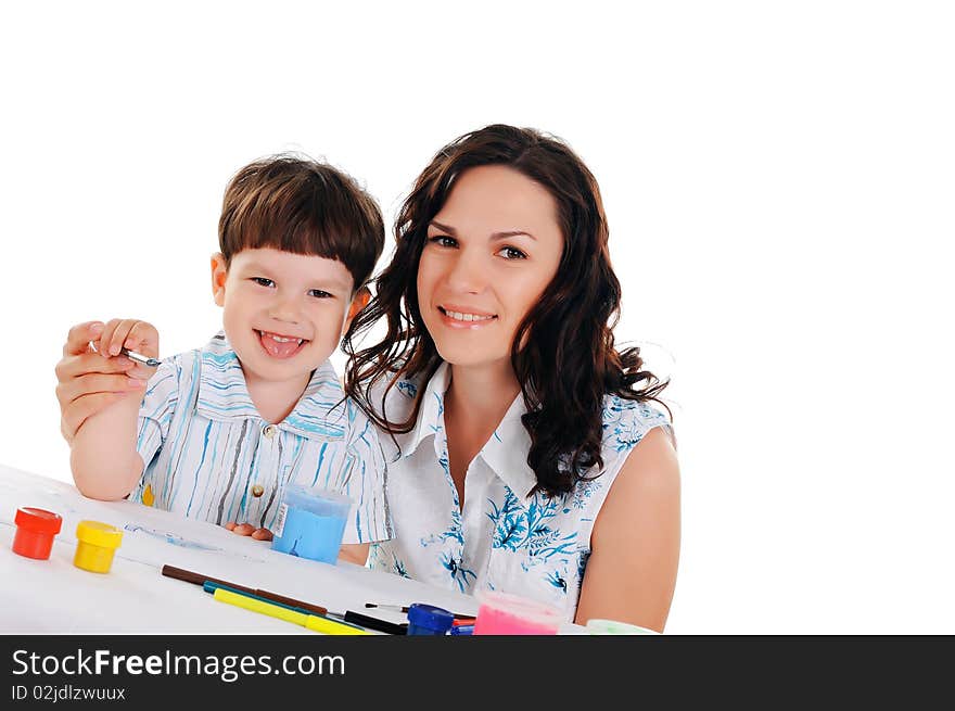 Young mother and her little son paint colors in this album. Young mother and her little son paint colors in this album