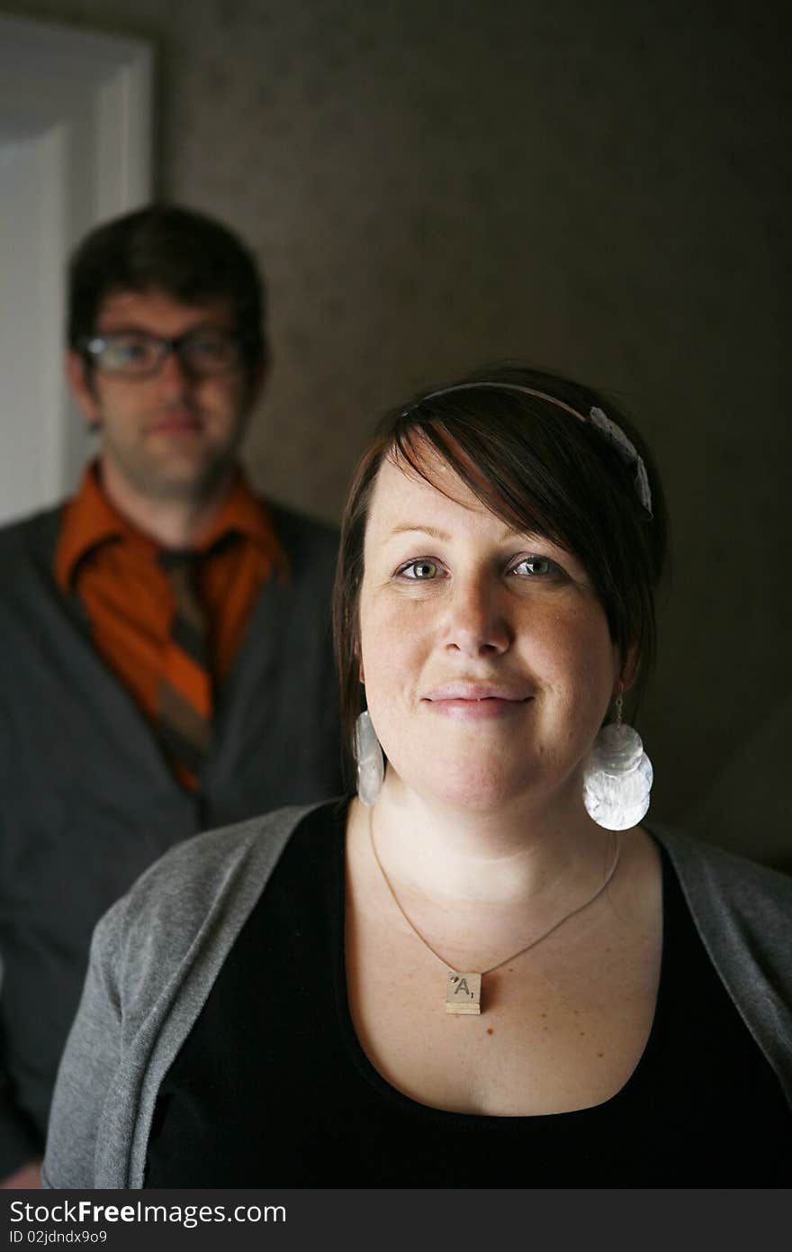 Portrait of young college age couple with woman in front in focus and man in background out of focus