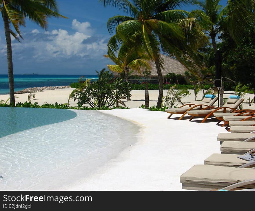 Beach beds near swimming pool. Beach beds near swimming pool.