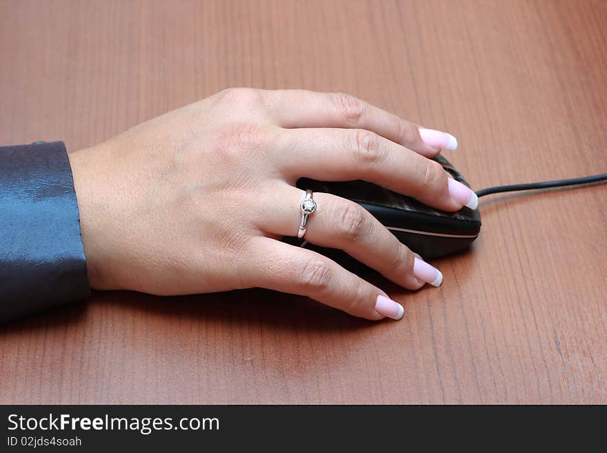 Woman's hand on computer mouse