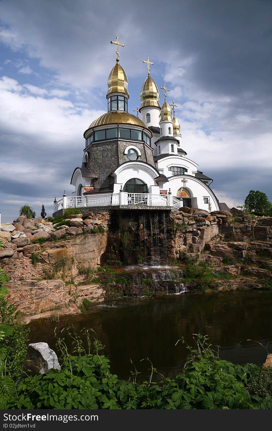 Gold-domed church under cloudy sky