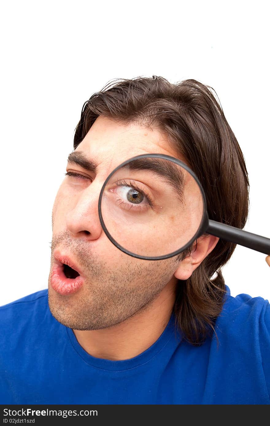 Man looking through magnifying glass