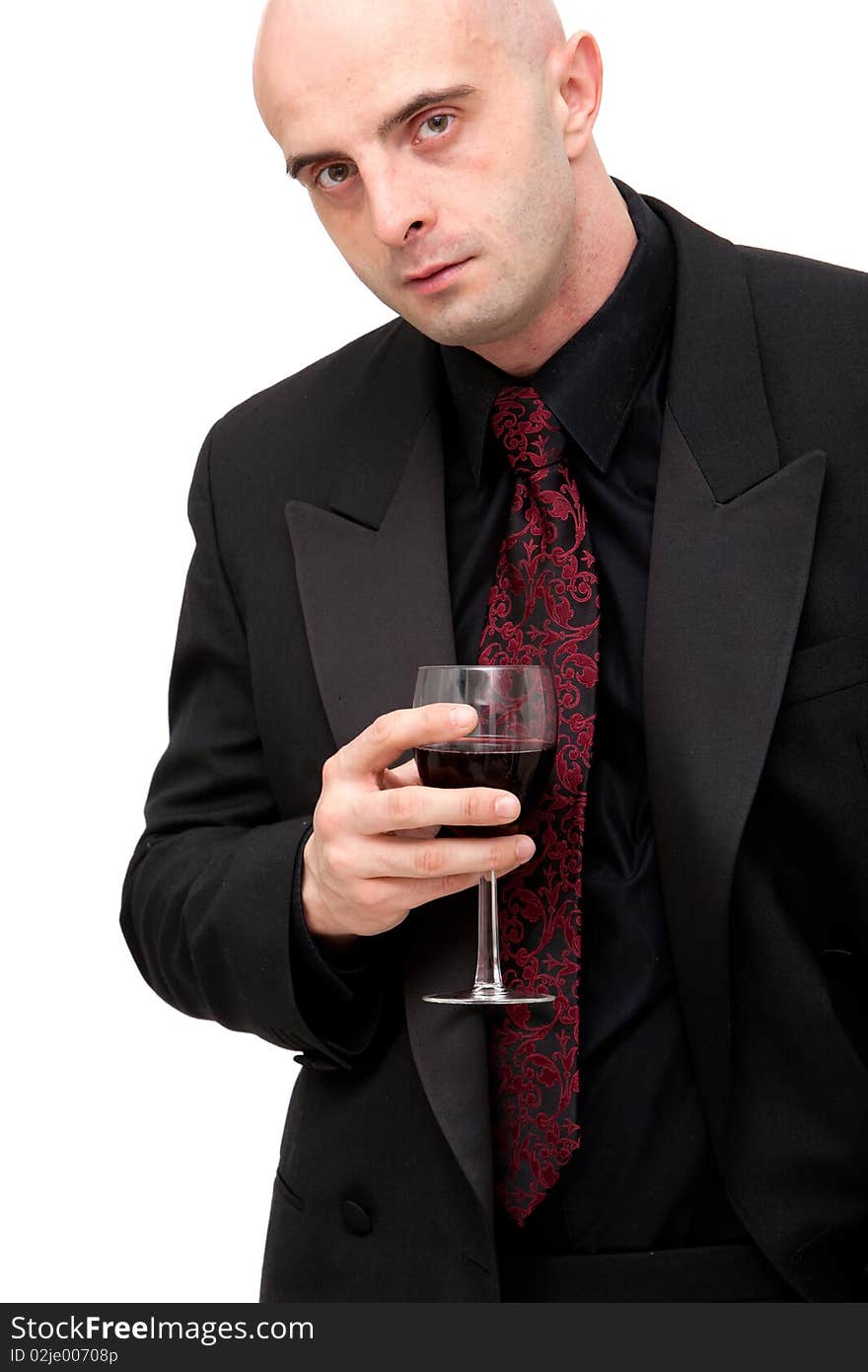 Young business man in dark suit holding a glass of wine. Young business man in dark suit holding a glass of wine