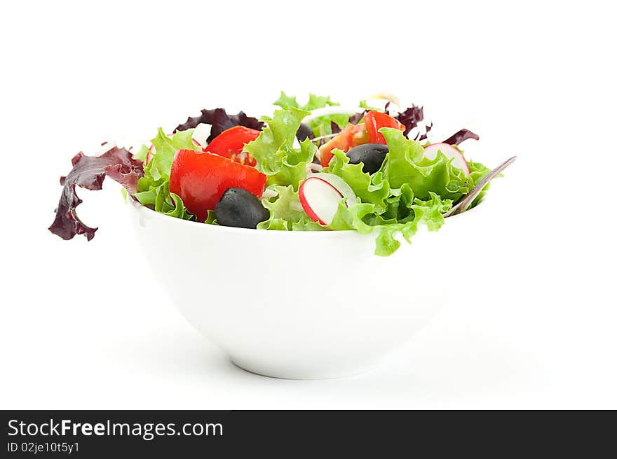 Fresh salad in a white bowl on a white background