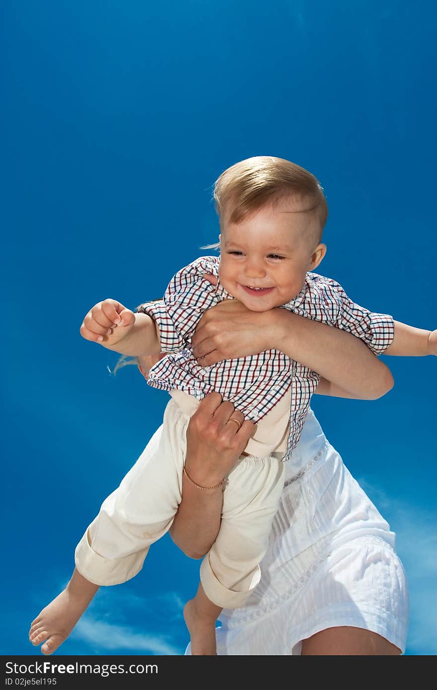 Laughing child on hands of mother. Laughing child on hands of mother