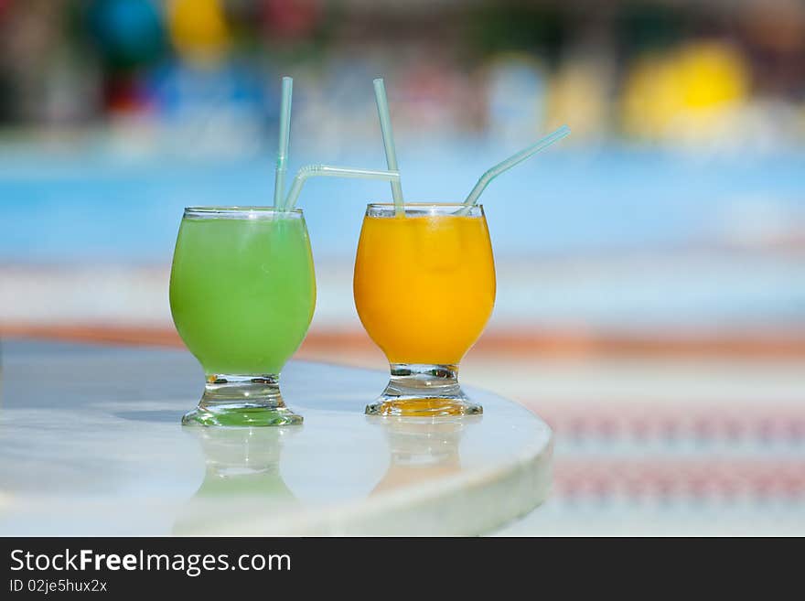 Two tropical cocktails on a table