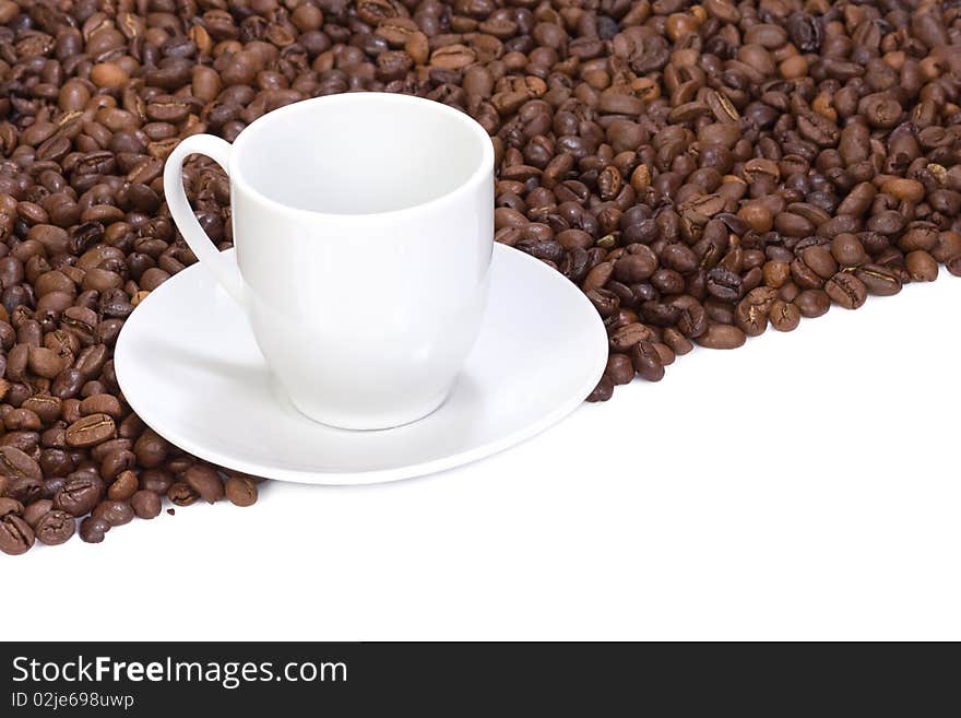 Coffee beans and empty cup