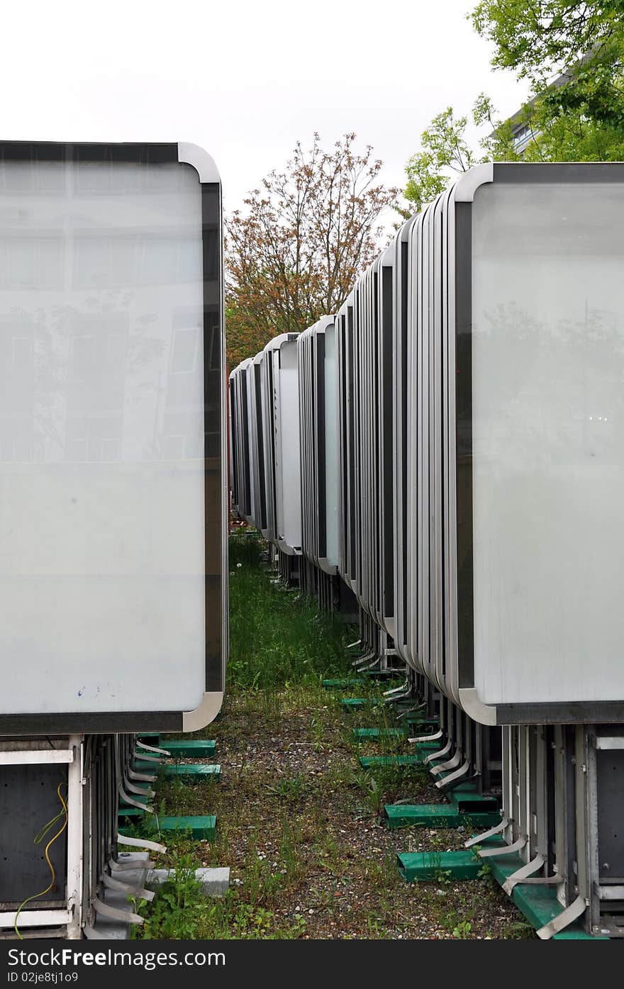 Rows of empty advertising boards stored in a backyard for later installation. Rows of empty advertising boards stored in a backyard for later installation