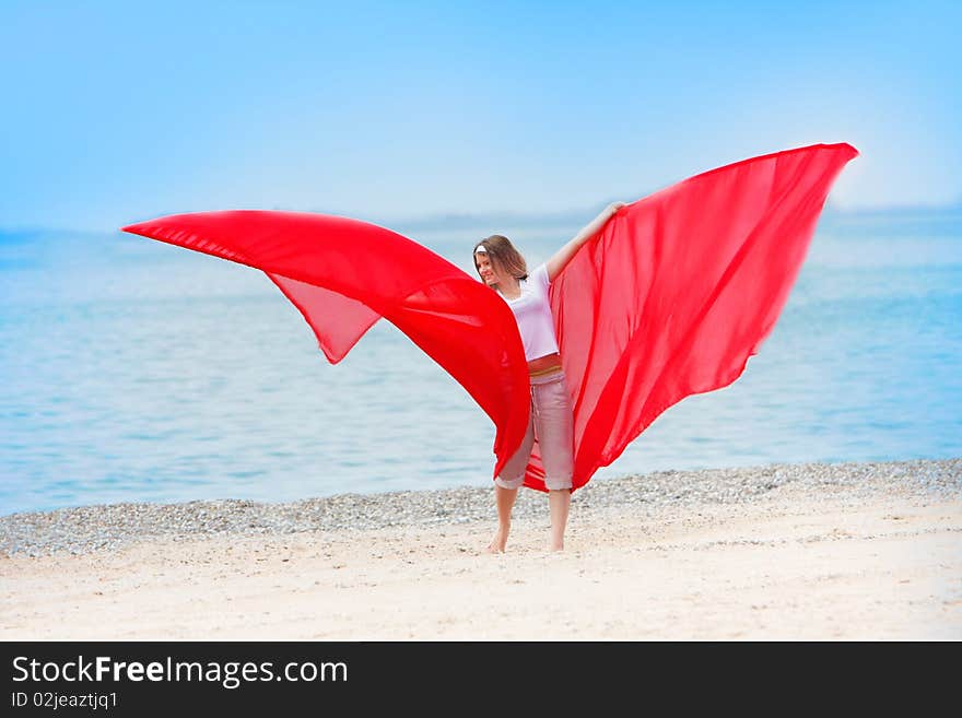 Young happy girl with red wings